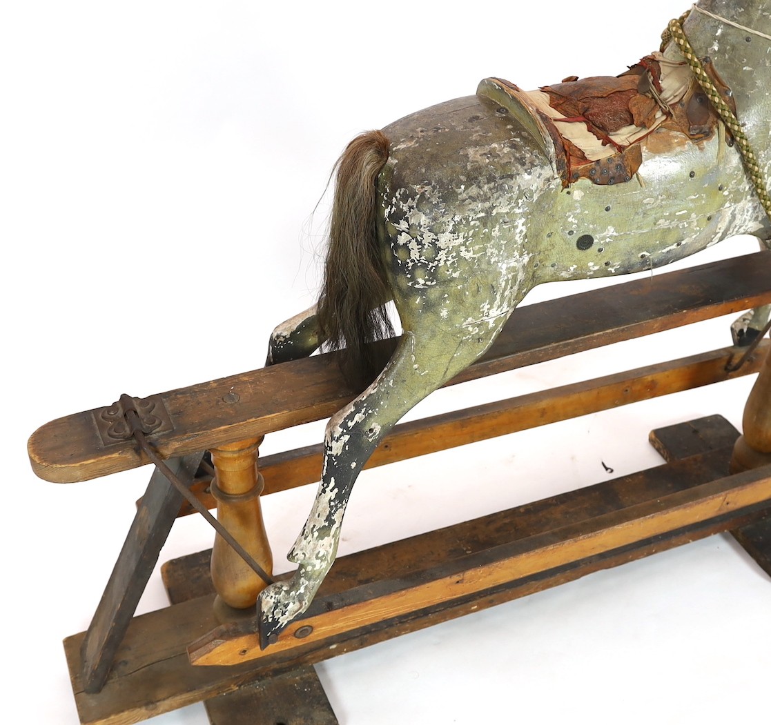 A Victorian carved and painted wood rocking horse, 174cm long 145cm high